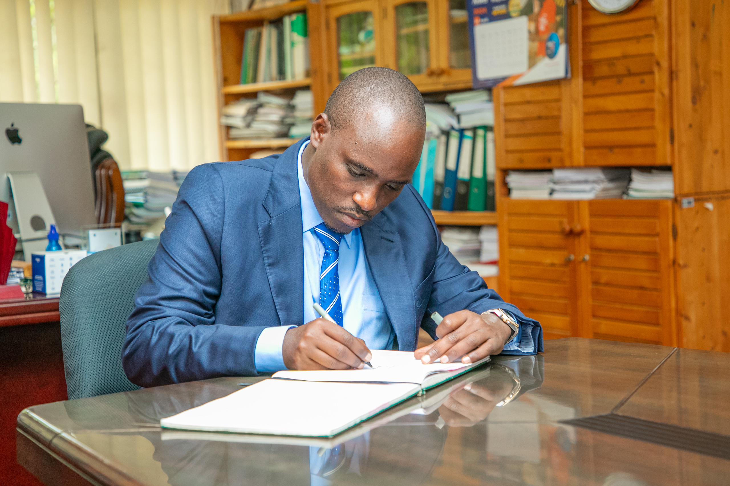 The Deputy Prime Minister and Minister of Energy, Hon. Dr. Doto Biteko Sign the Visitors Book at office of The Sokoine University Vice Chancela.